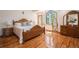 Inviting main bedroom featuring hardwood floors, wooden furniture, and a large window for natural light at 5542 Ponderosa Dr, Parker, CO 80134