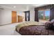 Spacious main bedroom with beautiful views from the large windows and comfortable king-size bed at 5542 Ponderosa Dr, Parker, CO 80134