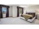 Bright main bedroom features large windows, plush carpeting, and a comfortable king-size bed at 5542 Ponderosa Dr, Parker, CO 80134