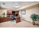 Finished office space in the basement features a built-in desk and storage cabinets for a professional environment at 5542 Ponderosa Dr, Parker, CO 80134
