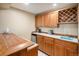 This wet bar boasts wood cabinetry and prep sink; ideal for entertaining or creating drinks at 5542 Ponderosa Dr, Parker, CO 80134