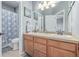 Bright bathroom features a double sink vanity and a shower with a decorative curtain at 28495 La Donna Vista Ln, Elizabeth, CO 80107