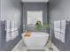 Bright bathroom features a modern stand alone tub, stylish fixtures and gray walls at 28495 La Donna Vista Ln, Elizabeth, CO 80107