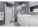 Modern bathroom with dual vanity, white cabinetry, and a glass-enclosed walk-in shower at 28495 La Donna Vista Ln, Elizabeth, CO 80107