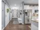 Bright entryway with hardwood floors, barn doors, and stainless steel refrigerator at 28495 La Donna Vista Ln, Elizabeth, CO 80107