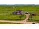 Spacious home with a long driveway and a large grassy yard, ideal for outdoor activities at 28495 La Donna Vista Ln, Elizabeth, CO 80107