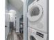 Upstairs laundry features stacked Bosch washer and dryer, and vinyl plank flooring at 28495 La Donna Vista Ln, Elizabeth, CO 80107