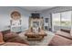 Cozy living room with a brick fireplace, rustic wood coffee table, and comfortable seating at 28495 La Donna Vista Ln, Elizabeth, CO 80107