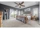 Comfortable main bedroom boasts a sliding glass door to balcony, rustic wood bedframe, and soft carpet at 28495 La Donna Vista Ln, Elizabeth, CO 80107