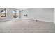 Large finished basement featuring plush carpeting, bright light, and sliding glass door at 10114 Atlanta St, Parker, CO 80134