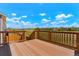 Deck overlooking a beautiful view with a wooden railing and wide plank flooring at 10114 Atlanta St, Parker, CO 80134