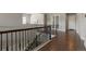 Hallway with hardwood floors and wrought iron banister at 10114 Atlanta St, Parker, CO 80134