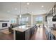 Modern kitchen with stainless appliances, granite counters, and open layout to living area at 10114 Atlanta St, Parker, CO 80134