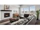Comfortable living space featuring a fireplace, hardwood floors, and large windows providing natural light and scenic views at 10114 Atlanta St, Parker, CO 80134