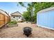 Inviting backyard featuring a fire pit, garden beds, storage shed, and charming detached structure at 2841 Stout St, Denver, CO 80205