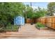 Backyard with lush landscaping, a storage shed, and wood fence at 2841 Stout St, Denver, CO 80205