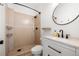 Modern bathroom with white vanity, dark fixtures, and tiled walk-in shower at 2841 Stout St, Denver, CO 80205