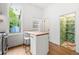 The kitchen features an island with seating, open pantry, and natural light from a large window at 2841 Stout St, Denver, CO 80205