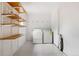 Functional laundry room with shelving, washer, and dryer at 2841 Stout St, Denver, CO 80205