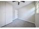 Neutral bedroom featuring gray carpet, white walls and trim, and a ceiling fan at 5350 E 66Th Way, Commerce City, CO 80022