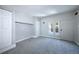 Bedroom features gray carpet, neutral paint, and plentiful storage at 5350 E 66Th Way, Commerce City, CO 80022