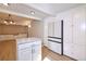 Bright kitchen featuring white cabinets, stainless steel appliances, an island, and new floors at 5350 E 66Th Way, Commerce City, CO 80022