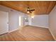 Open living room with updated floors, a ceiling fan, and access to a half bath at 5350 E 66Th Way, Commerce City, CO 80022