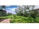 Expansive backyard with lush greenery, mature trees, and partial view of home at 7194 S Himalaya Way, Centennial, CO 80016
