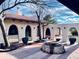 Backyard with a decorative brick firepit and multiple archways on a stucco wall at 7194 S Himalaya Way, Centennial, CO 80016