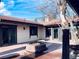 Backyard patio featuring a unique brick firepit, stucco walls, and sliding glass doors at 7194 S Himalaya Way, Centennial, CO 80016