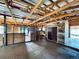 Spacious barn interior features wooden stalls, brick flooring and high ceilings with exposed beams, great for equestrian needs at 7194 S Himalaya Way, Centennial, CO 80016