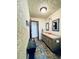 Bathroom features a double sink vanity, decorative mirrors, and tiled flooring at 7194 S Himalaya Way, Centennial, CO 80016