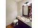 Cozy bathroom with decorative mirror, granite countertop, and vintage fixtures at 7194 S Himalaya Way, Centennial, CO 80016
