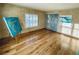 Bedroom features hardwood flooring and a bright window plus unique artwork at 7194 S Himalaya Way, Centennial, CO 80016
