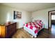 Cozy bedroom featuring hardwood floors, a colorful quilt, and a vintage dresser at 7194 S Himalaya Way, Centennial, CO 80016