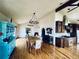 Dining room with hardwood floors, chandelier, and a view into the kitchen with stainless steel appliances at 7194 S Himalaya Way, Centennial, CO 80016