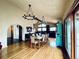 Open dining area with hardwood floors, chandelier, and a view into the adjacent kitchen at 7194 S Himalaya Way, Centennial, CO 80016