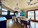 Dining room featuring hardwood floors, wooden table with 8 chairs, and windows for plenty of light at 7194 S Himalaya Way, Centennial, CO 80016