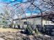 Backyard view with stucco siding, clay tile roof, and landscaping at 7194 S Himalaya Way, Centennial, CO 80016