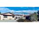 Inviting front of house with gravel yard, stucco siding, and arched fencing at 7194 S Himalaya Way, Centennial, CO 80016