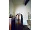Hallway featuring hardwood floors, an arched doorway, and a decorative cabinet at 7194 S Himalaya Way, Centennial, CO 80016