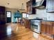 Bright kitchen featuring stainless steel oven, wooden cabinets, and a built-in hutch and dining set at 7194 S Himalaya Way, Centennial, CO 80016