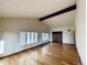 Living room showcasing hardwood floors, window with plantation shutters, and beamed ceilings at 7194 S Himalaya Way, Centennial, CO 80016