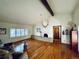 Spacious Living Room showcasing brick fireplace and mantle, vaulted ceiling with wood beam at 7194 S Himalaya Way, Centennial, CO 80016