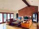Cozy living room with brick fireplace, wood beam, hardwood floors and comfortable seating at 7194 S Himalaya Way, Centennial, CO 80016