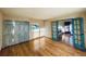 Open living room with hardwood floors, blue accents, and sliding glass doors to laundry at 7194 S Himalaya Way, Centennial, CO 80016