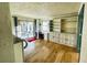 Bright living room boasts built-in shelving and cabinet, plus a sliding glass door to the outside at 7194 S Himalaya Way, Centennial, CO 80016