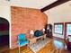 Inviting living room features a brick fireplace with a hearth and brick accent wall at 7194 S Himalaya Way, Centennial, CO 80016