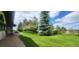 Well-manicured yard featuring green grass and mature trees, creating a serene outdoor space at 7194 S Himalaya Way, Centennial, CO 80016