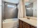 Updated bathroom with gray tile, bathtub and vanity at 12460 S Hollow Creek Ct, Parker, CO 80134